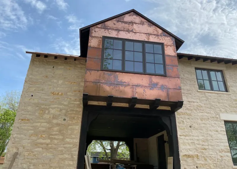 Copper metal panel facade on a stone building for Skylight Installation in Rainbow Springs
