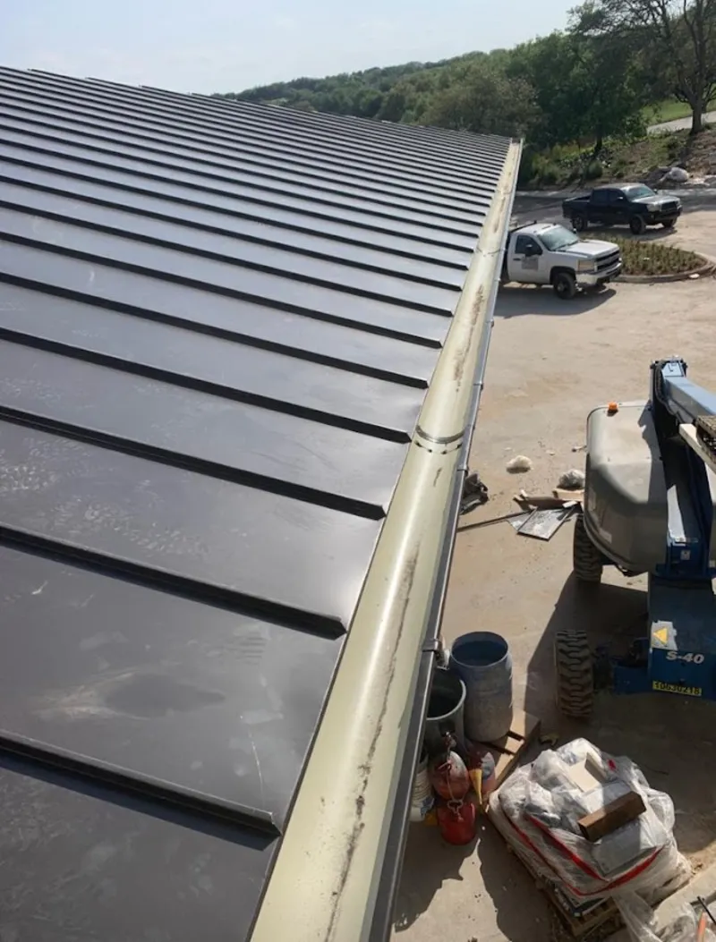 Standing seam panel and gutter detail on a metal roofing jobsite in Rainbow Springs